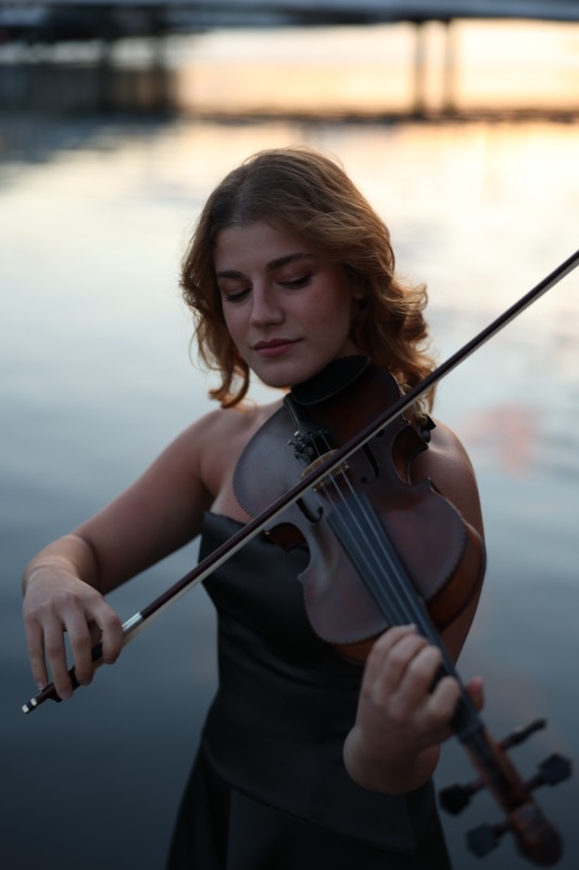 Ariadni playing by the harbour at sunset